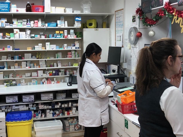 2 people working in a pharmacy